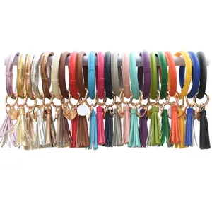 Bracciale portachiavi rotondo in pelle PU colorata con ciondolo nappina, accessorio.