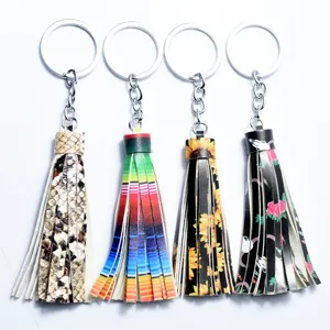 Detailed view of 4 stylish leather tassel keychains with unique patterns like snakeskin and sunflower.