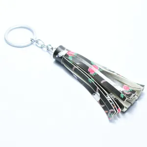 Leather tassel keychain detail view, floral print bag charm pendant for women, stylish accessories.