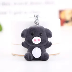 Cute black flocked plush pig keychain bag pendant accessory for women and girls daily use.
