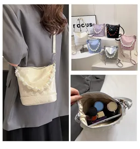 Niche design women's bucket bag, handmade pearl handle, chic PU leather crossbody shoulder bag.