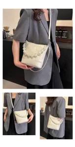 Stylish white bucket bag for women with pearl handle, chic crossbody and shoulder design.