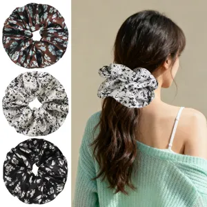Floral hair scrunchie detail view showcasing smooth fabric, elastic band, and vintage floral print.