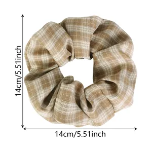 Brown plaid hair scrunchie detail view, showing 14cm elastic hair tie and fabric texture.