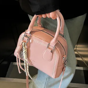 Stylish pink patent leather shell handbag for women, trendy commute shoulder crossbody bag.