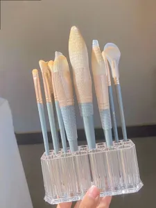 Clear acrylic multi-hole makeup brush holder detail display showing storage capacity.