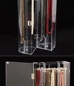 Detail view of transparent acrylic necklace organizer with hooks and dustproof door.
