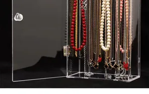 Clear acrylic necklace organizer with dustproof door, vertical hanging rods for jewelry display.