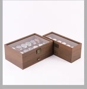 Detailed view of wooden watch box with clear glass lid and drawers, premium display storage.