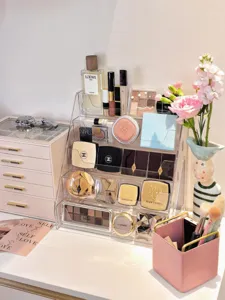 Clear acrylic tiered cosmetic organizer showing detailed storage design on desktop.