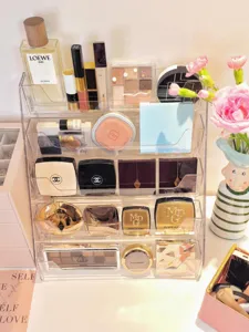 Clear acrylic tiered cosmetic organizer for desktop storage of lipsticks, eyeshadows and makeup.