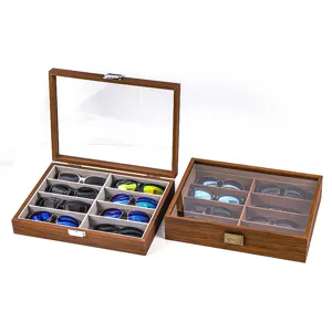 Wooden sunglasses storage box detail showing multi-grid organizer with clear glass lid.