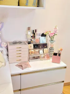 Clear acrylic trapezoidal makeup organizer display stand for cosmetics, lipstick and palette.