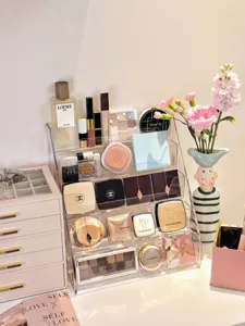 Clear acrylic makeup organizer multi-tier trapezoid cosmetic display rack for desktop vanity storage.