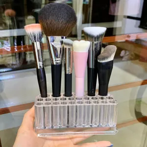 Clear acrylic makeup brush holder multi-hole organizer for cosmetic tools and pencils.