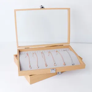 Wooden velvet necklace display box with glass lid for jewelry organization and retail counter.