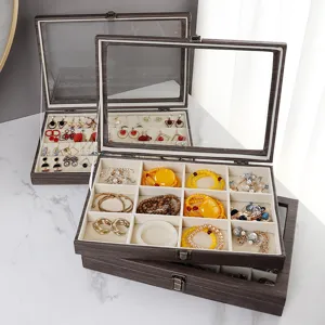 Wooden jewelry organizer box with clear glass lid, multi-grid velvet storage for rings and earrings.