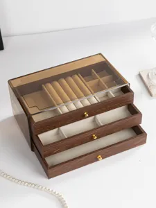 Wooden jewelry box with drawer design, transparent cover, and soft velvet lining for rings and necklaces.