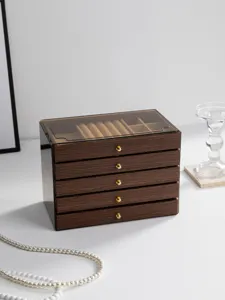 Detailed view of the multi-layer walnut wood grain jewelry storage box with drawers and clear lid.