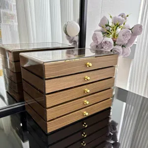 Multi-layer drawer jewelry organizer box with walnut wood grain finish and clear acrylic body.