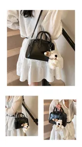 Minimalist black patent leather boston handbag with cute plush puppy charm for women daily fashion style
