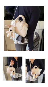 Detail view of stylish white shoulder crossbody bag featuring a cute plush bear pendant.