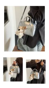 Silver metallic handle shoulder crossbody bag with plush dog charm for women, stylish detail view