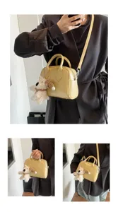 Stylish yellow leather shoulder bag with cute plush dog charm, chic crossbody design.