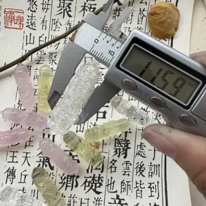 Natural crystal carved pendant detail shot showing precise size with caliper measurement.
