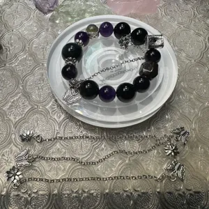 Handmade black purple beaded bracelet set with silver butterfly flower charms for women.