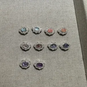 Natural crystal silver DIY jewelry findings details featuring various gemstone charms assortment.