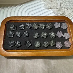 Detailed close-up of carved flower crystal beads, DIY jewelry accessories and components.