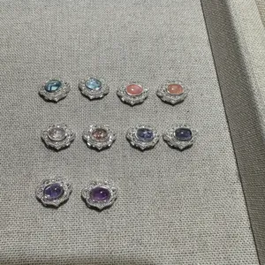 Detail view of natural gemstone DIY silver jewelry accessories featuring various crystal cabochons