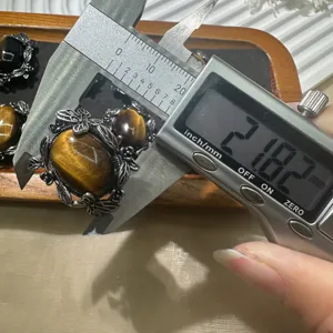 Tiger eye stone pendant detail shot showcasing 21mm size measurement with digital caliper.