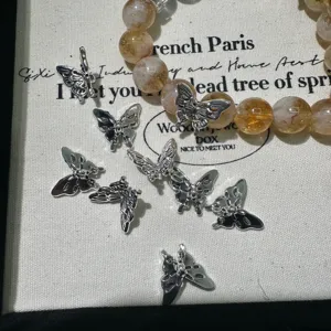 Tibetan silver butterfly charms and crystal bead bracelet detail accessories collection.