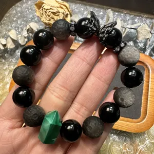 Handcrafted natural stone bracelet featuring obsidian, malachite point and butterfly charm.