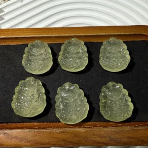 Detail shot showing six light yellow crystal nine-tailed fox pendant carved pieces.