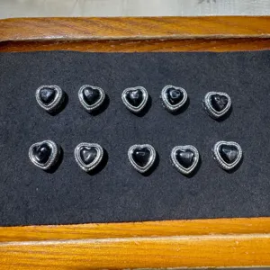 Black heart silver-plated metal beads with holes for DIY jewelry making and craft supplies.