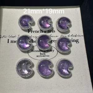 Detailed view of purple crescent gemstone pendants with rhinestone border, 21x19mm DIY charm.