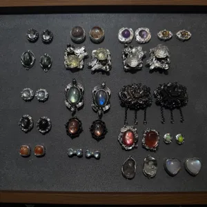 Vintage gemstone cabochon metal findings detail shot, retro silver finish jewelry parts assortment.