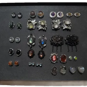Vintage gemstone copper settings and cabochon pendants flat lay display accessories collection.