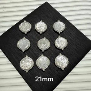 Close-up of round mother-of-pearl deity pendants with pearl edges, 21mm for DIY jewelry crafting.