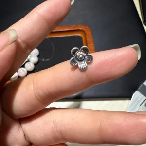 Alloy flower spacer bead for DIY jewelry making, vintage silver tone craft component detail view.