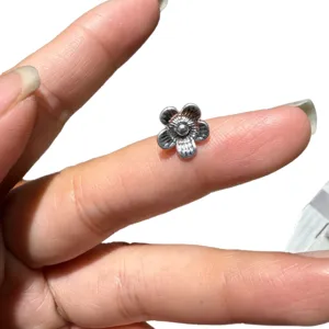 Retro metal flower spacer beads for DIY jewelry making, vintage style charm bracelet components.