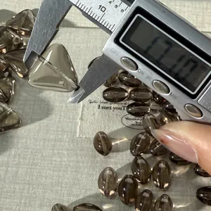 Natural smoky quartz crystal loose beads gemstone measurement detail close-up view accessory.