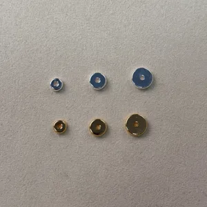 Close-up of smooth round spacer beads in gold and silver, perfect for DIY jewelry crafting.
