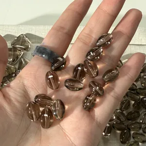 Detail shot of natural smoky quartz olive beads, showing crystal clear transparency for DIY jewelry.