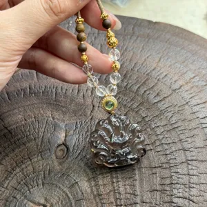 Smoky quartz crystal fox pendant necklace featuring wooden beads and clear crystal detail.