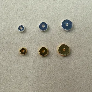 Round metal spacer beads for DIY jewelry making, smooth gold and silver tone detail view.