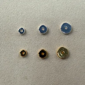 Detailed shot of smooth round metal spacer beads in silver and gold for DIY jewelry crafting.